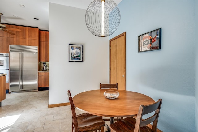 dining area with stone finish flooring and baseboards