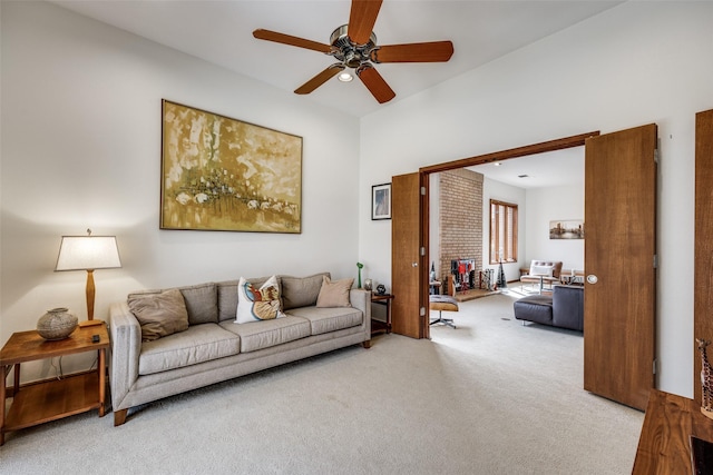 carpeted living room featuring a ceiling fan