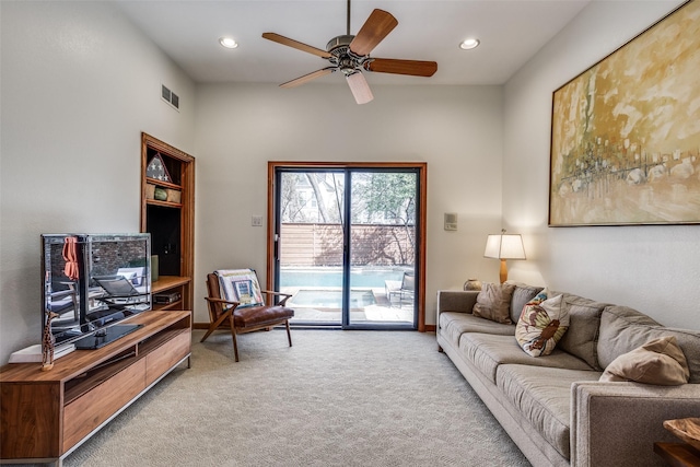 carpeted living area with ceiling fan, visible vents, and recessed lighting