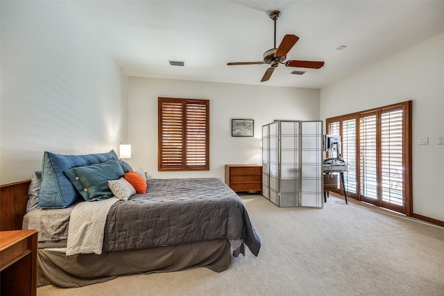 carpeted bedroom featuring access to outside, visible vents, and a ceiling fan