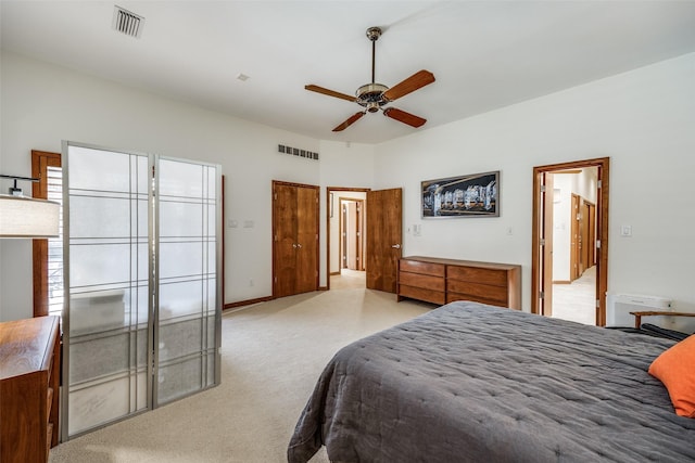 bedroom with visible vents, ceiling fan, light carpet, and baseboards