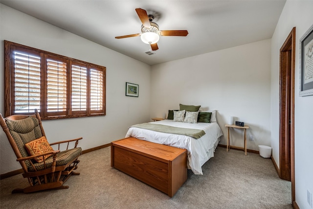 bedroom featuring baseboards, visible vents, ceiling fan, and light colored carpet