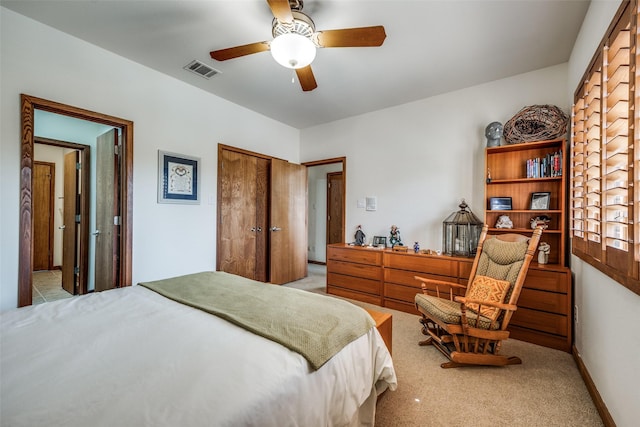 carpeted bedroom with a ceiling fan, baseboards, visible vents, and a closet