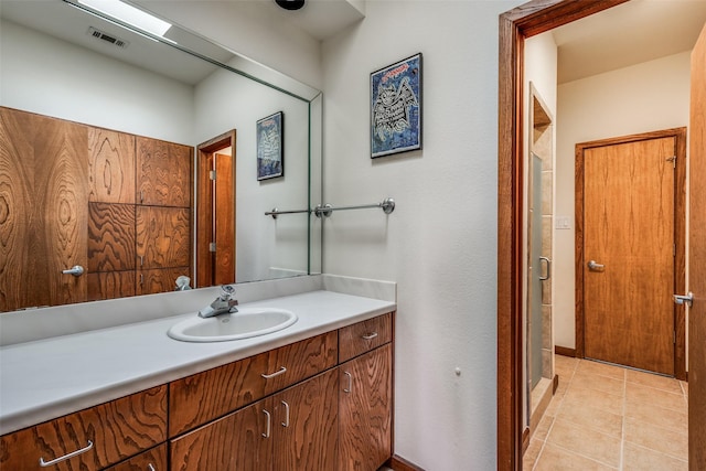 full bathroom featuring a stall shower, visible vents, vanity, and tile patterned floors