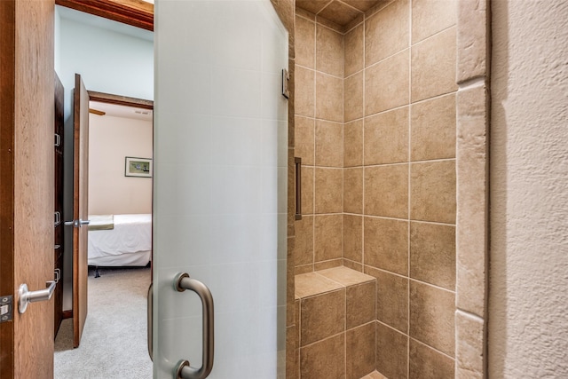 ensuite bathroom featuring tiled shower and ensuite bathroom