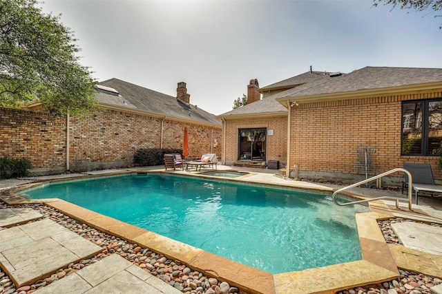 view of pool with an in ground hot tub, a fenced in pool, and a patio