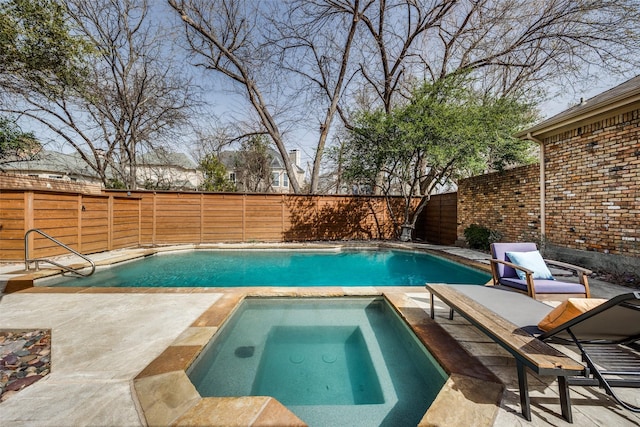 view of pool with an in ground hot tub, a patio, a fenced backyard, and a fenced in pool