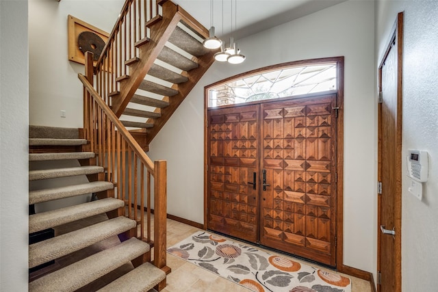 entryway with stairs and baseboards