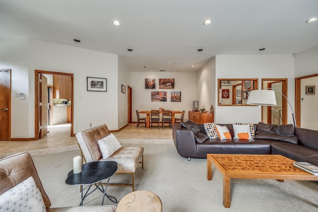 living area featuring recessed lighting, light carpet, and baseboards