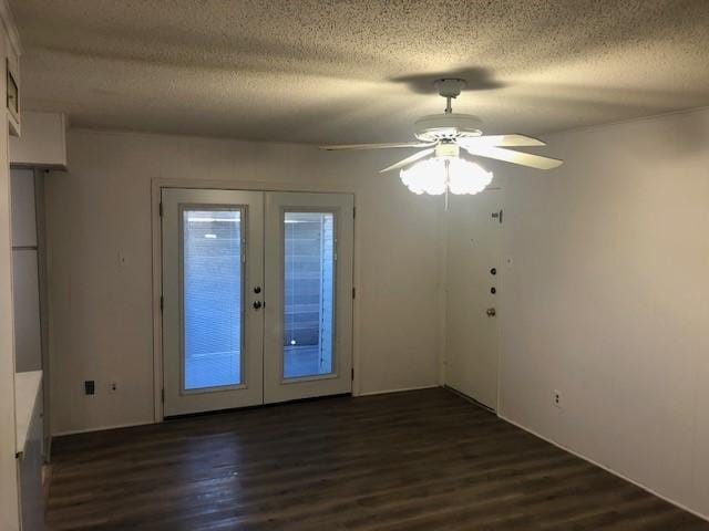 spare room featuring a ceiling fan, french doors, a textured ceiling, and wood finished floors