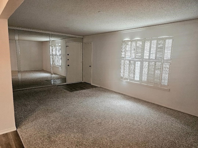 5825 Birchbrook Dr Unit 106, Dallas, TX 75206 - foyer entrance with a textured ceiling, carpet flooring, and baseboards