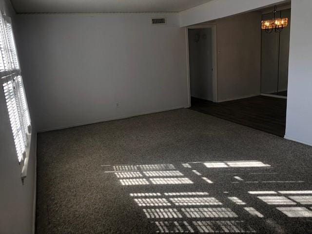 spare room with visible vents and an inviting chandelier