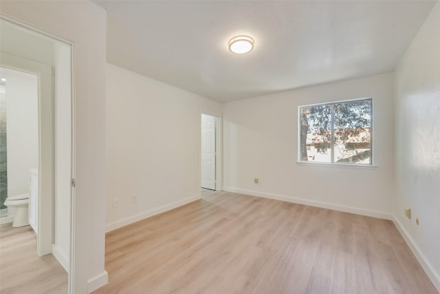 unfurnished room featuring light wood-type flooring and baseboards