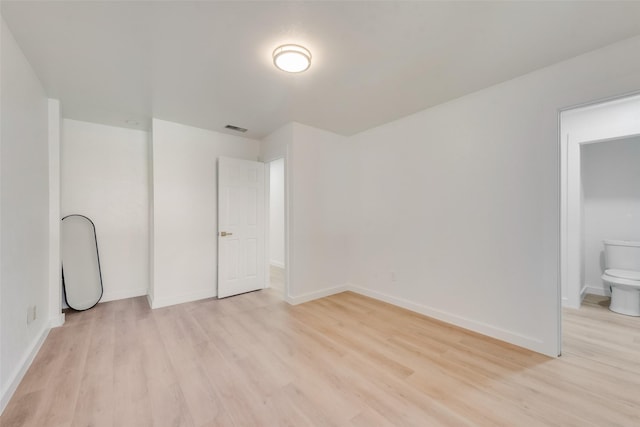 unfurnished bedroom with light wood-style flooring, visible vents, and baseboards