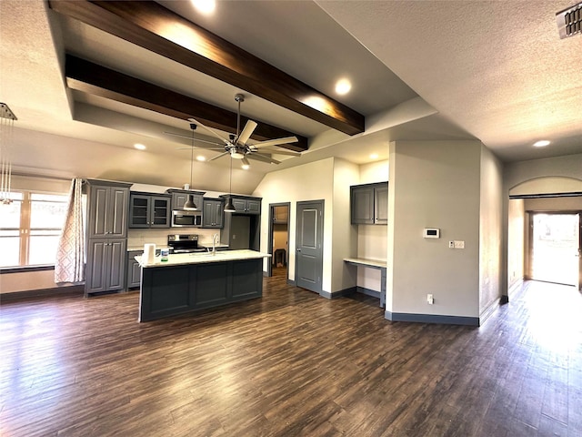 kitchen featuring a ceiling fan, dark wood-style floors, stainless steel appliances, light countertops, and baseboards