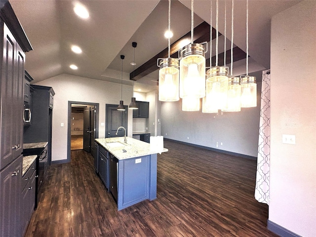 kitchen featuring baseboards, light stone countertops, dark wood finished floors, an island with sink, and a sink