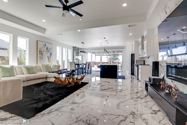 living room featuring recessed lighting, marble finish floor, visible vents, and ceiling fan