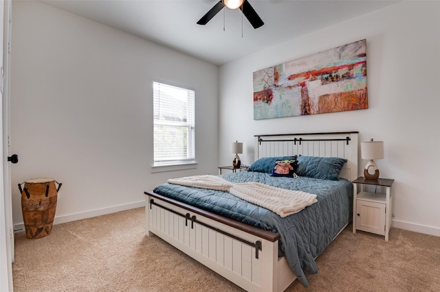 carpeted bedroom with ceiling fan and baseboards