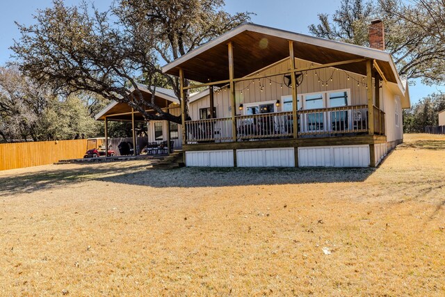 rear view of property featuring fence and a chimney