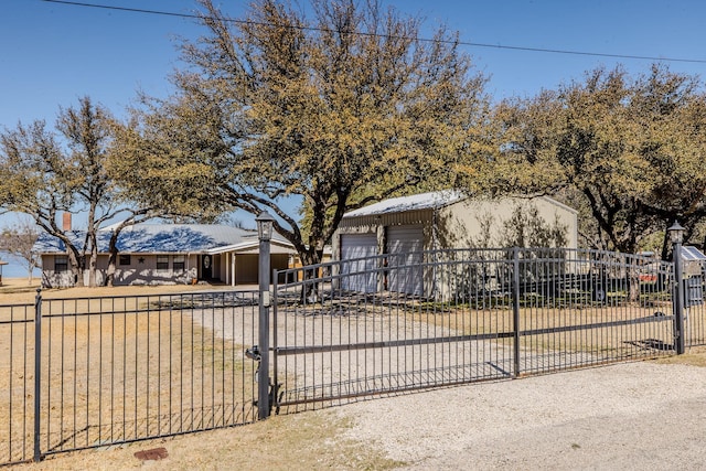 view of front of home with an outbuilding, a garage, and a fenced front yard