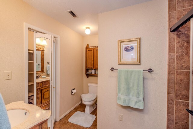 full bathroom with visible vents, baseboards, toilet, tile patterned floors, and vanity