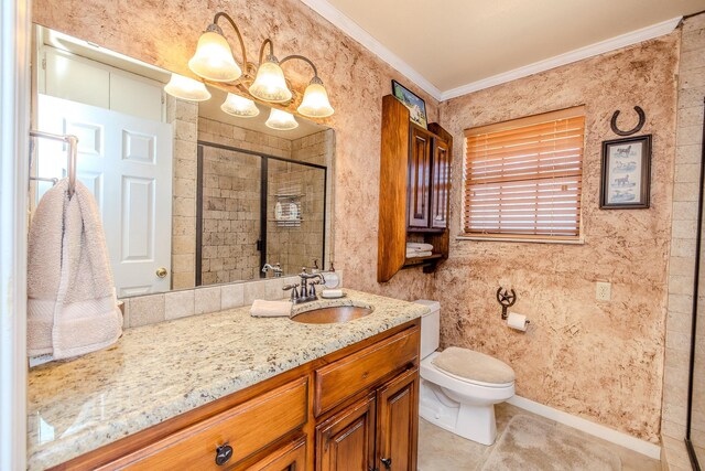 bathroom with vanity, ornamental molding, a shower stall, tile patterned floors, and toilet