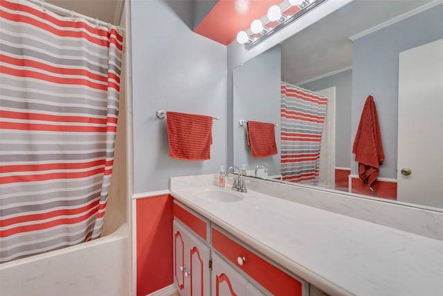 bathroom with baseboards, shower / tub combo, vanity, and crown molding