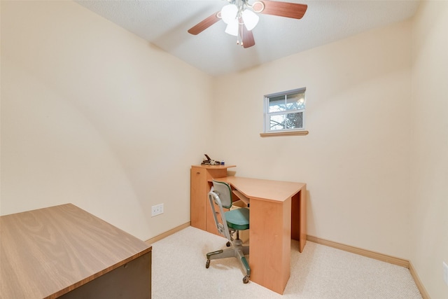 office space with baseboards, carpet floors, and a ceiling fan