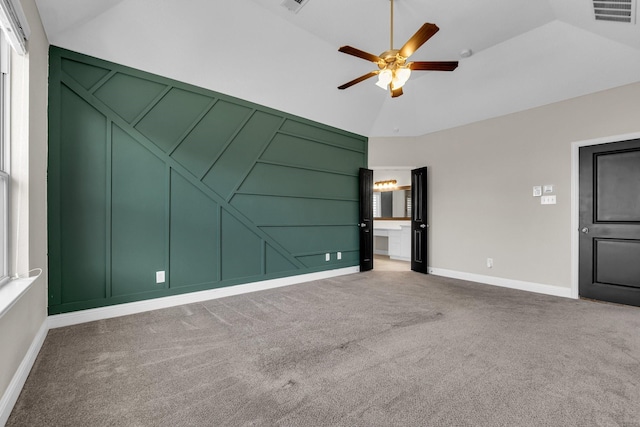 unfurnished bedroom featuring a decorative wall, carpet flooring, and visible vents