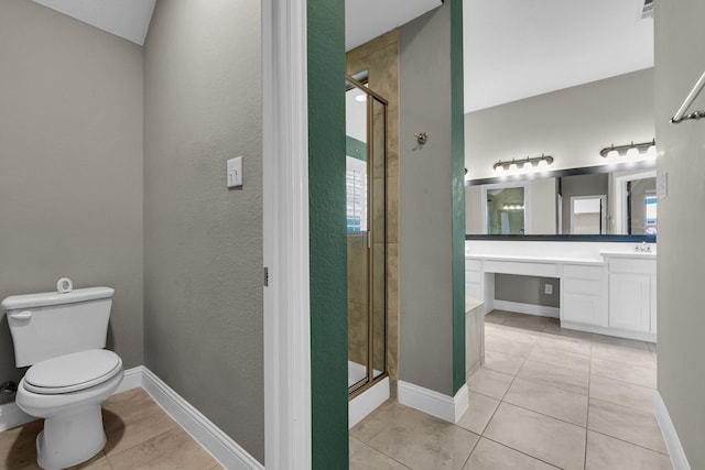 bathroom featuring vanity, toilet, baseboards, and a stall shower