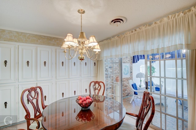 dining space with a chandelier, visible vents, and a textured ceiling