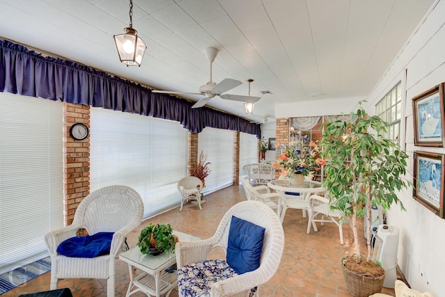 living area with visible vents and ceiling fan