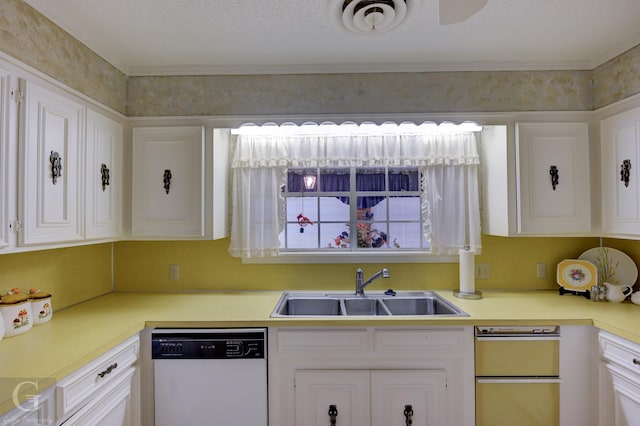 kitchen with a sink, white cabinets, white dishwasher, and light countertops