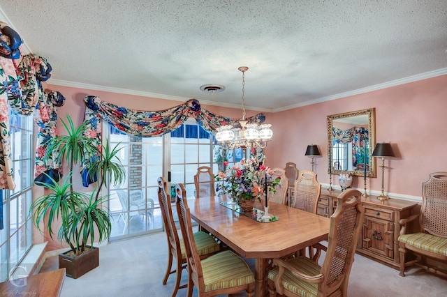 dining area with a textured ceiling, ornamental molding, visible vents, and light carpet