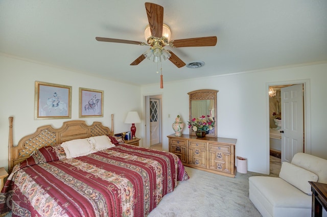 bedroom with a ceiling fan, visible vents, carpet floors, ornamental molding, and ensuite bathroom