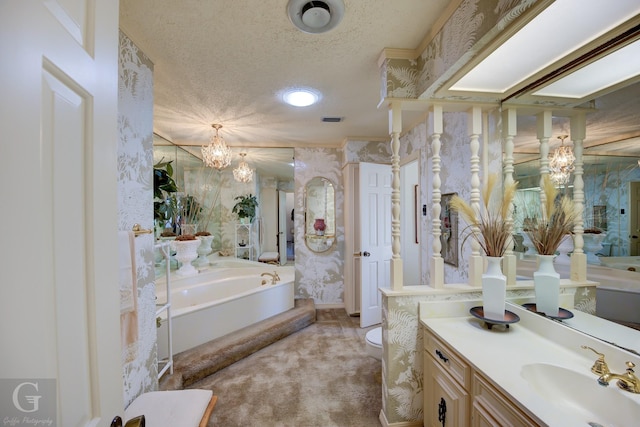 bathroom with vanity, visible vents, wallpapered walls, a textured ceiling, and a garden tub