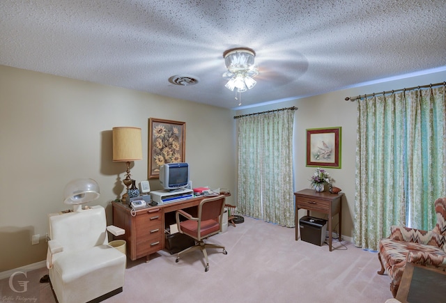 office area with baseboards, a textured ceiling, and carpet flooring