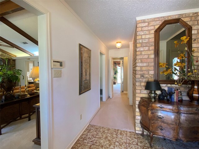 hallway with brick wall, a textured ceiling, and crown molding