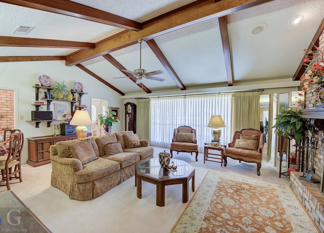 living room featuring visible vents, a textured ceiling, light colored carpet, a brick fireplace, and vaulted ceiling with beams