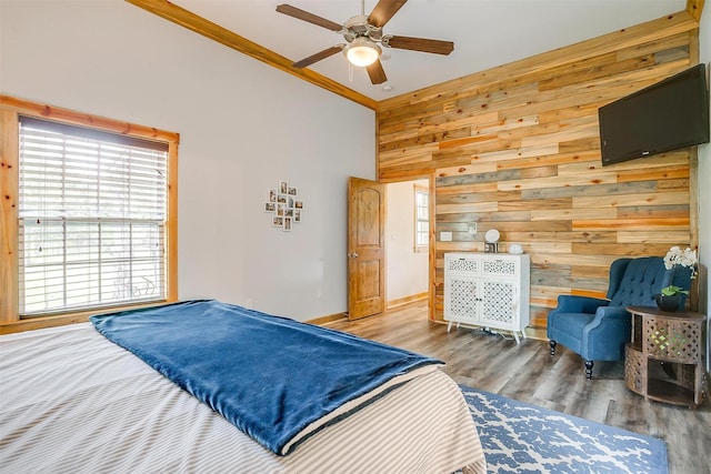 399 Brindley Rd, Maypearl, TX 76064 - bedroom with baseboards, ornamental molding, ceiling fan, wooden walls, and wood finished floors