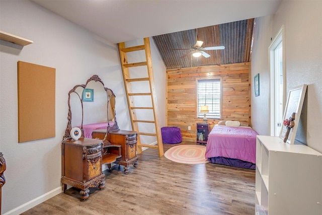 399 Brindley Rd, Maypearl, TX 76064 - bedroom featuring baseboards, wooden walls, and wood finished floors
