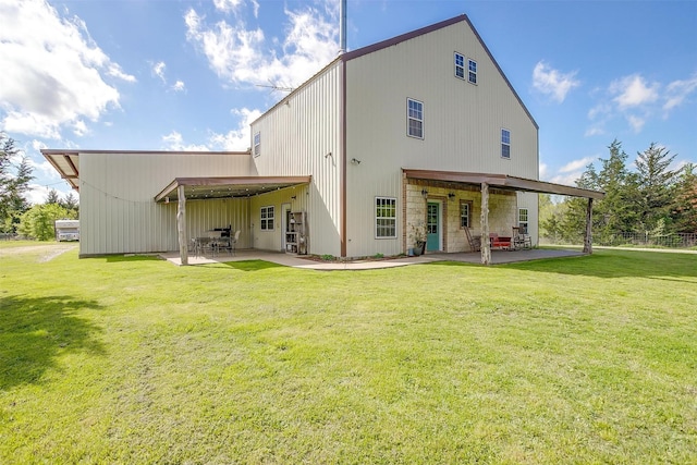 rear view of property featuring a patio and a lawn