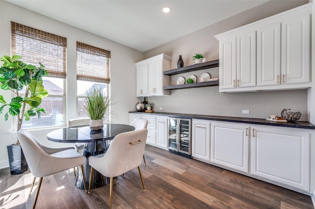 interior space with dark wood-type flooring, recessed lighting, and beverage cooler