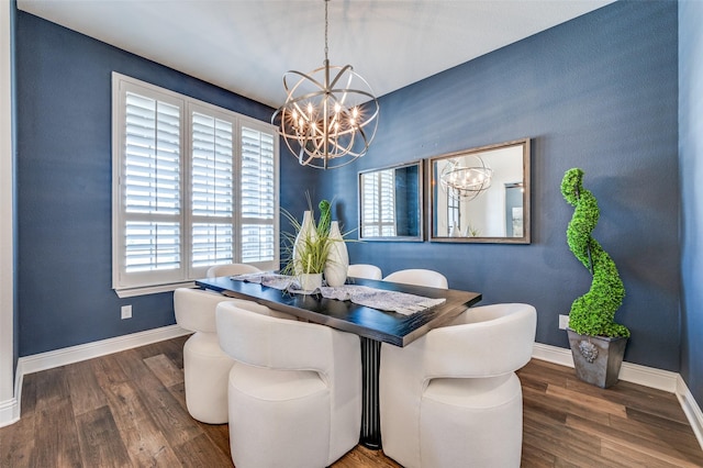 dining space with an inviting chandelier, baseboards, and wood finished floors