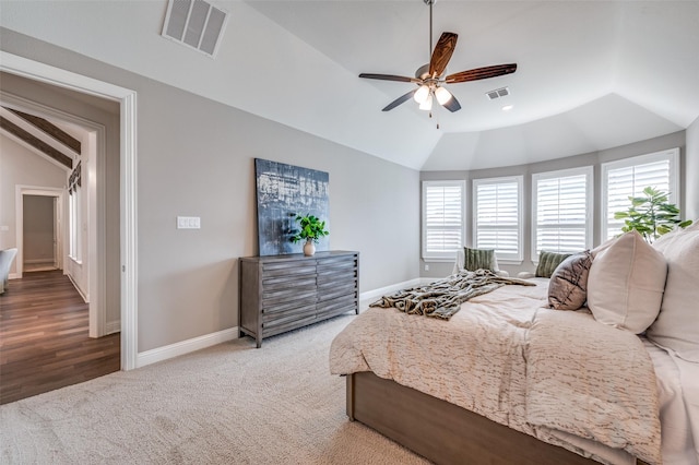 carpeted bedroom featuring lofted ceiling, a ceiling fan, visible vents, and baseboards