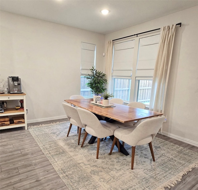 dining space with recessed lighting, baseboards, and wood finished floors