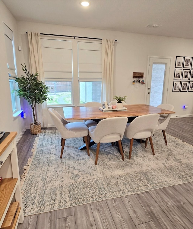 dining area with baseboards, visible vents, wood finished floors, and recessed lighting