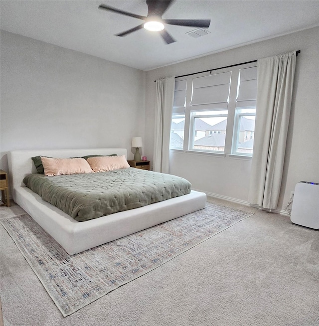 bedroom with carpet, visible vents, ceiling fan, and baseboards