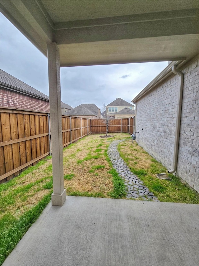 view of yard featuring a patio area and a fenced backyard