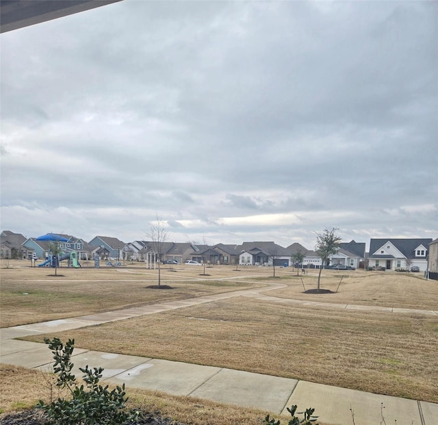 view of yard featuring a residential view and playground community